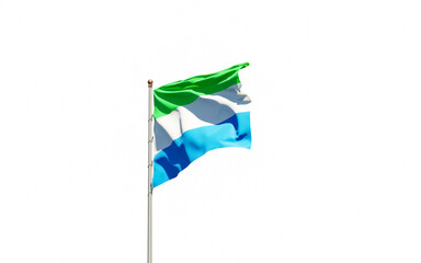National state flag of Sierra Leone fluttering at sky background.
