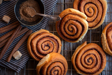 Fresh home baked sweet cinnamon buns on dark background