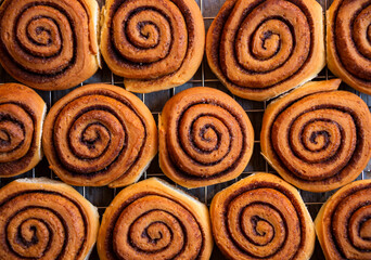 Fresh home baked sweet cinnamon buns on dark background