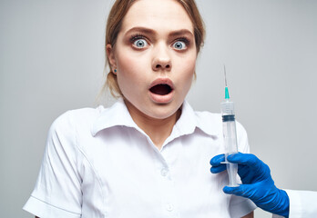 Frightened patient And syringe in hand blue gloves medicine