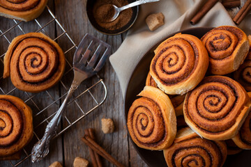 Fresh home baked sweet cinnamon buns on dark background