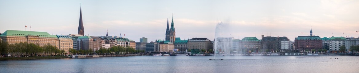 panorama of the city Hamburg in Germany, water fountains in the foreground 