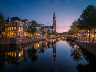 View over the Prinsengracht canal to the Anne Frank House and the Westertoren church tower at dusk
