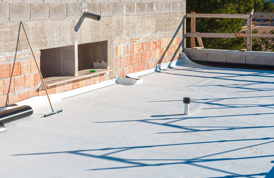Worker applies pvc membrane roller on roof very carefully. Correct welding with hand-welder, corner.