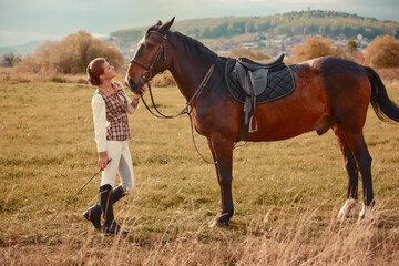 Woman with her horse at sunset, autumn outdoors scene