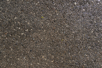 Background and texture of asphalt road with wet of water.