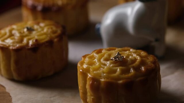 Mooncake a Chinese traditional pastry for Mid-Autumn festival. set on rustic wooden table.