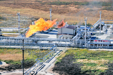 An industrial facility of the oil industry, a gas compressor station, tanks with oil products,...