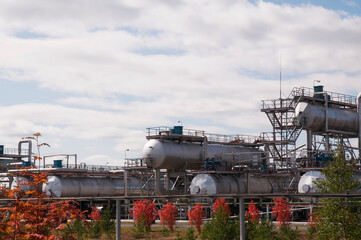 Large Oil Industrial Facility, equipment, pipelines, tanks with oil products, utilities.