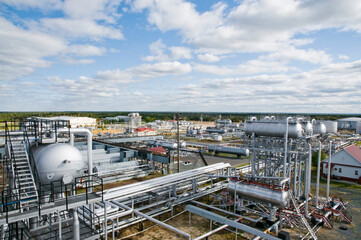 Large Oil Industrial Facility, equipment, pipelines, tanks with oil products, utilities.