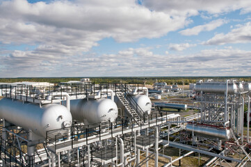 Large Oil Industrial Facility, equipment, pipelines, tanks with oil products, utilities.