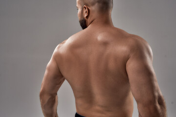 Fototapeta premium Young caucasian athlete showing muscular back