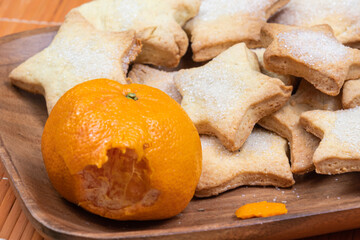 homemade, delicious, sweet,Christmas,new year, holiday cookies with tangerines,oranges on a wooden plate, orange bamboo napkin at home
