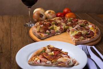 Portuguese Pizza slice made with ham, pea egg, heart of palm, pepperoni, onion and mozzarella and bacon. Served on the plate.Gastronomy photography.