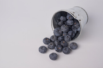 Berry background. Fresh berry blueberries on a white background. Concept of healthy and diet food. Flat lay, top view, Ripe blueberries with copy space for text, shallow DOF