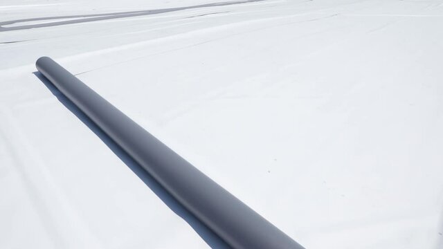 A roll of synthetic pvc membrane on a flat roof