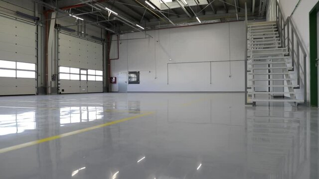 New epoxy floor with colored markings in a car workshop.