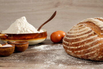bread and flour on wooden table close up