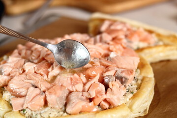 Spoon juice from lemon and butter remaining from frying Salmon over filling. Making Salmon in Puff Pastry Series.
