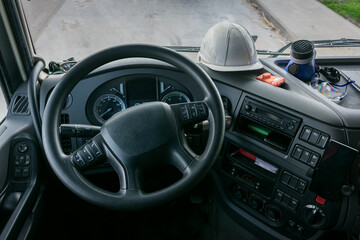 Personal protective equipment in the cabin of a truck that transports dangerous goods, consisting of a helmet, protective glasses, gas mask and an explosimeter.