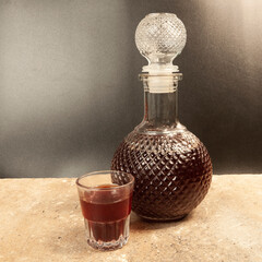 decanter with and a glass with red wine on the background