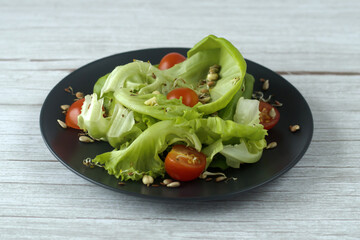 healthy food - green salad, cherry tomatoes, sprouted wheat and bean 