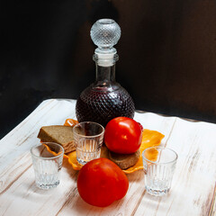 decanter with red wine and tomatoes