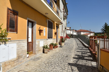 A narrow street among the old houses of Pietrelcina, a medieval village in the Campania region, Italy.