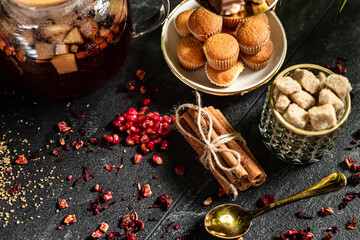 Fruit hot tea with the addition of oranges, lemons, mandarins and raspberries in a glass cups on a table. Healthy hot drink. tea with fruit and berries in a glass teapot. tea for colds.