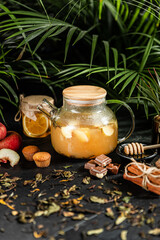 Fruit hot tea with the addition of oranges, lemons, mandarins and raspberries in a glass cups on a table. Healthy hot drink. tea with fruit and berries in a glass teapot. tea for colds.
