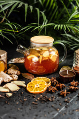 Fruit hot tea with the addition of oranges, lemons, mandarins and raspberries in a glass cups on a table. Healthy hot drink. tea with fruit and berries in a glass teapot. tea for colds.