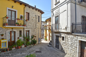 Fototapeta na wymiar A narrow street among the old houses of Pietrelcina, a medieval village in the Campania region, Italy.