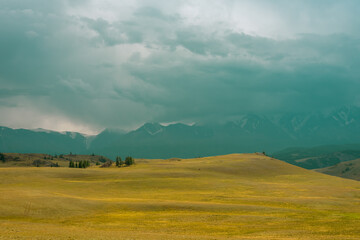 Majestic mountain landscape under the sky with clouds. Cloudy sky before the storm