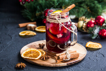 Christmas hot mulled wine with cinnamon cardamom and anise. Dark vintage dirty background. Creative...