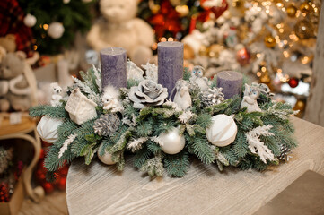 chic Christmas arrangement of fir branches decorated with cones, flowers, toys and balls