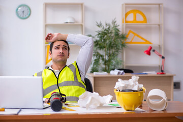 Young male architect working in the office