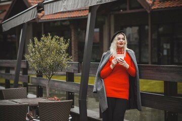 Woman at European cafe, plus size blonde nice woman . Pretty nice girl in restaurant at terrace with a cup of coffee, lifestyle ladies, tourist at Europe 