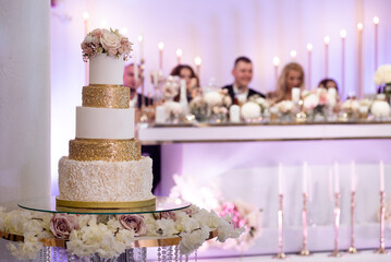 Wedding cake on the background of people. Wedding cake with candles and peoples on background