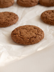 Oatmeal cookies on white background in morning light close up