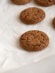 Oatmeal cookies on white background in morning light close up