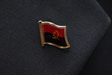 Angola flag lapel pin on a suit