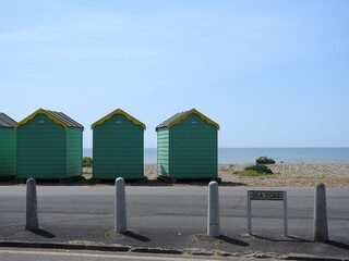 Naklejka premium Sea road sign, street, coastal colorful sheds and sea