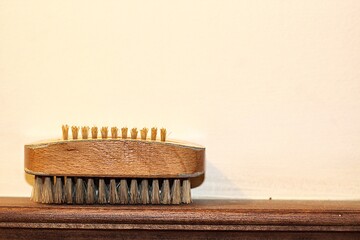 wooden brush  leaning  against  the wall