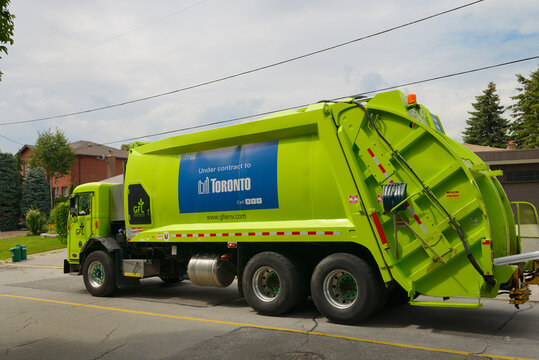 Green Garbage And Recycling Truck In Toronto, Canada - July  31, 2013