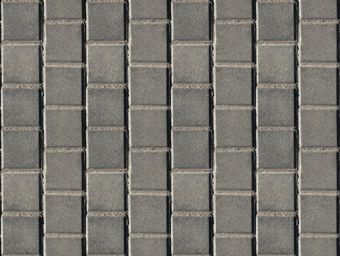 Coating with modern textured paving tiles of square shape.