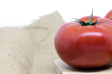 tomatoes on a wooden table with white background