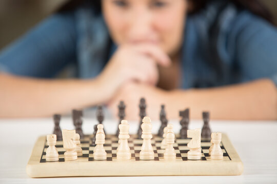 A Woman Is Playing Chess Alone