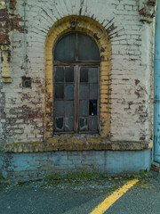 Old window with broken glass of old building