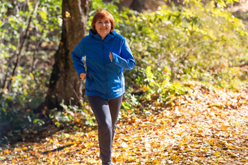 Active middle-aged woman  jogs runs