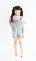 Full length of happy and funny face expression asian little child girl dress in casual standing in white room.